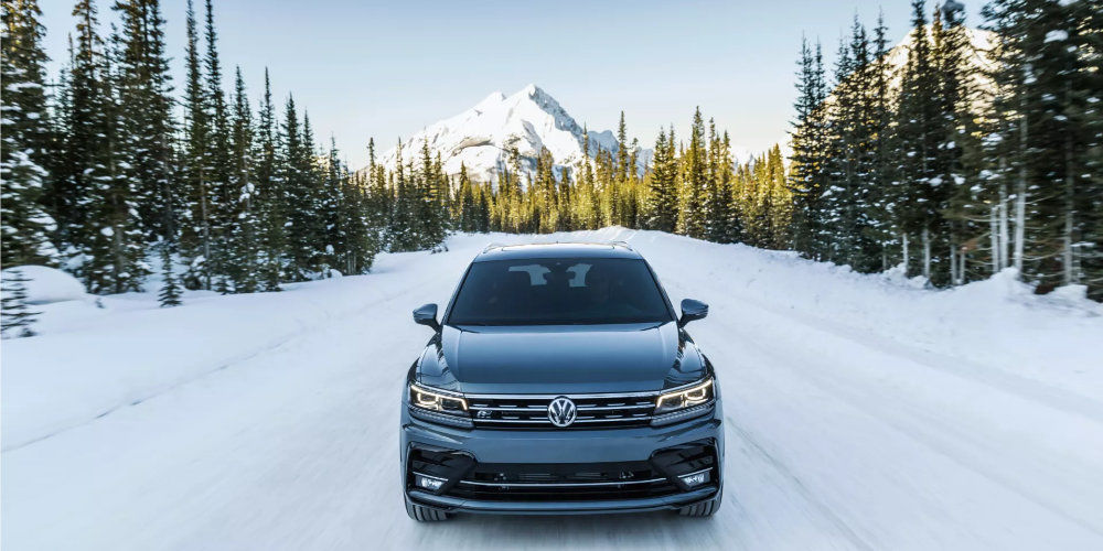 frontal view of a VW vehicle on a snowy road