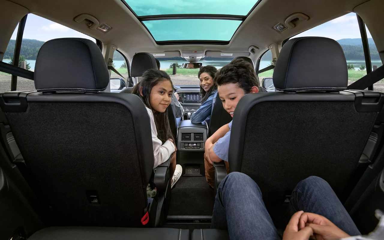 cockpit view of a 2023 VW Atlas and a family interacting within