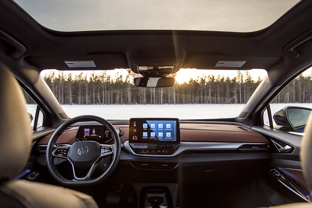 view inside of the 2021 Volkswagen ID.4 with the steering wheel, central dashboard and glass roof