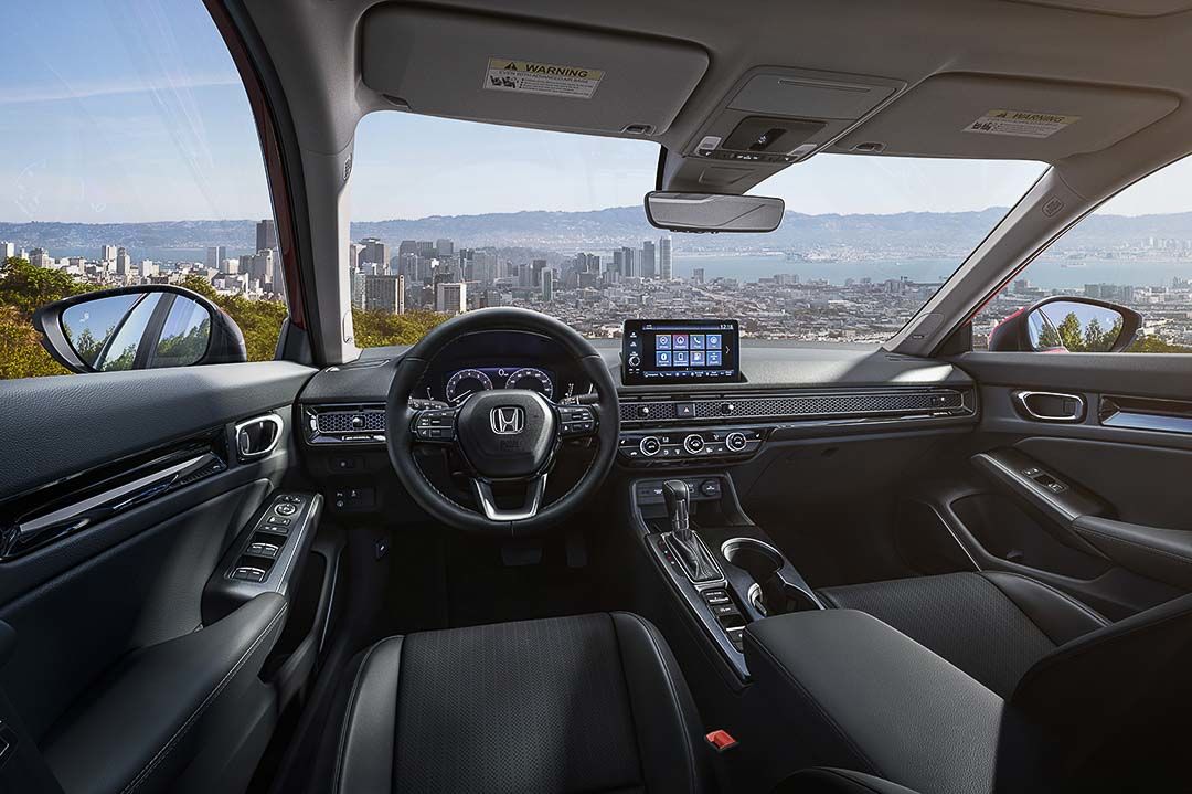 interior view of the 2022 Honda Civic with the steering wheel and central dashboard