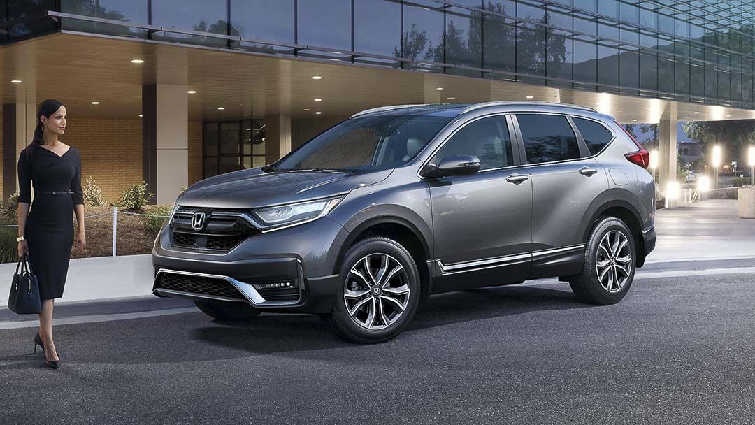 side view of the 2021 Honda CR-V parked in front of a building