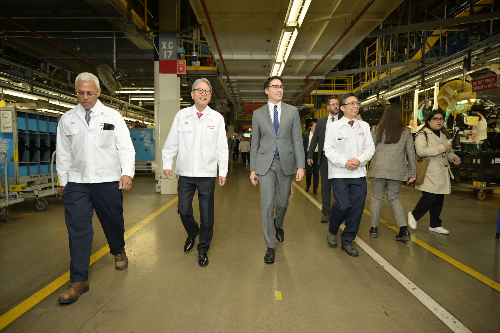 The Right Honourable Justin Trudeau, Prime Minister of Canada (centre) walks with Toshihiro Mibe, President and CEO of Honda Motor Co. (second from left), at Honda of Canada Mfg., where the company announced a $15-billion investment to build a comprehensive electric vehicle value chain in Canada.