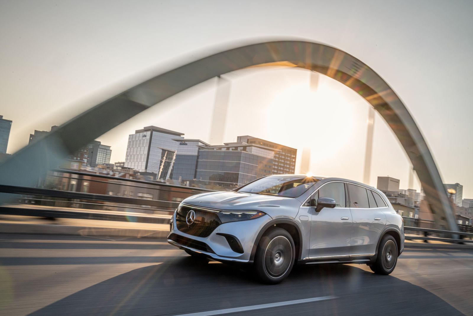 2026 Mercedes-Benz EQS SUV - A silver 2026 Mercedes-Benz EQS SUV driving across a bridge - Mercedes-Benz Brampton - New car dealership in Brampton, Ontario