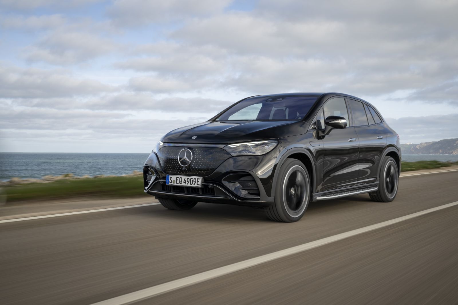2026 Mercedes-Benz EQE SUV - A black 2026 Mercedes-Benz EQE SUV driving on a coastal road - Mercedes-Benz Brampton - New car dealership in Brampton, Ontario