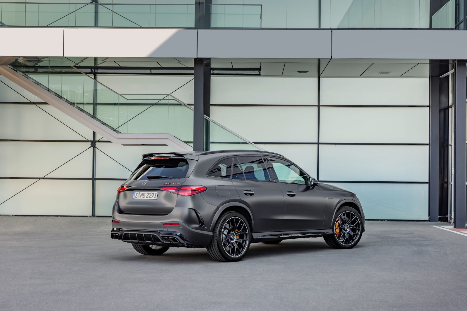 2026 Mercedes-AMG GLC 63 S - Rear three-quarter view of a matte grey 2026 Mercedes-AMG GLC 63 S E Performance showing the quad exhaust tips and rear diffuser - Mercedes-Benz Brampton - New car dealership in Brampton, Ontario