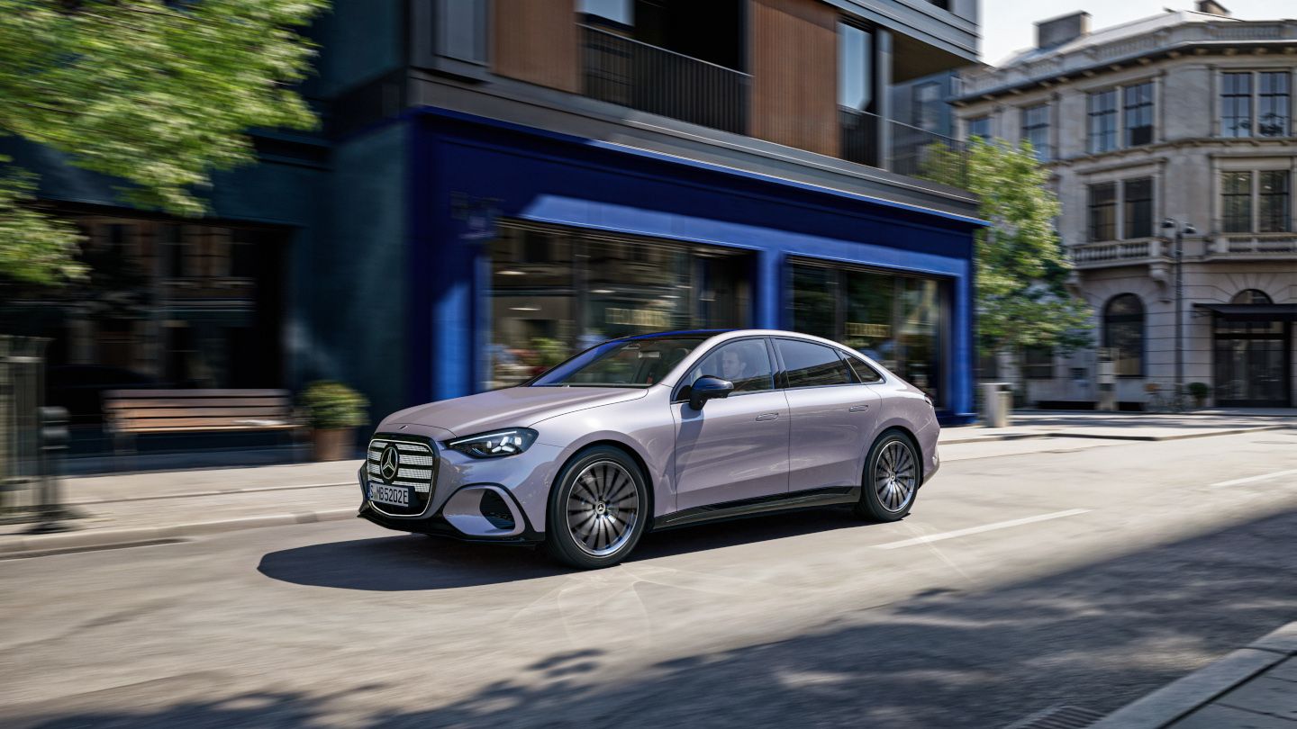 2027 Mercedes-Benz C-Class - front three-quarter view of a 2027 Mercedes-Benz C-Class driving along a city street - Mercedes-Benz Brampton - Mercedes-Benz new car dealership in Brampton, Ontario