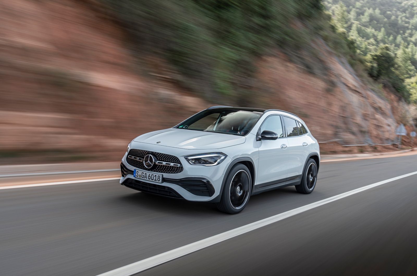 2026 Mercedes-Benz GLA 250 - Front three-quarter view of a white 2026 Mercedes-Benz GLA 250 driving on a highway - Mercedes-Benz Brampton - New car dealership in Brampton, Ontario