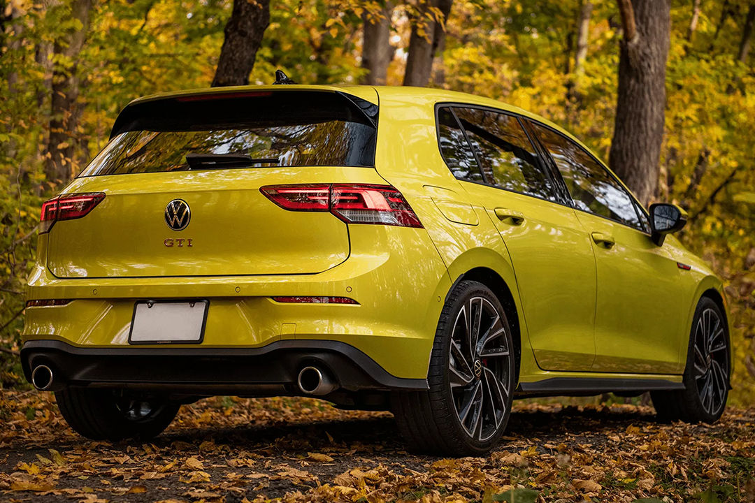 Rear view of the 2024 Golf GTI on a country road on an autumn's day