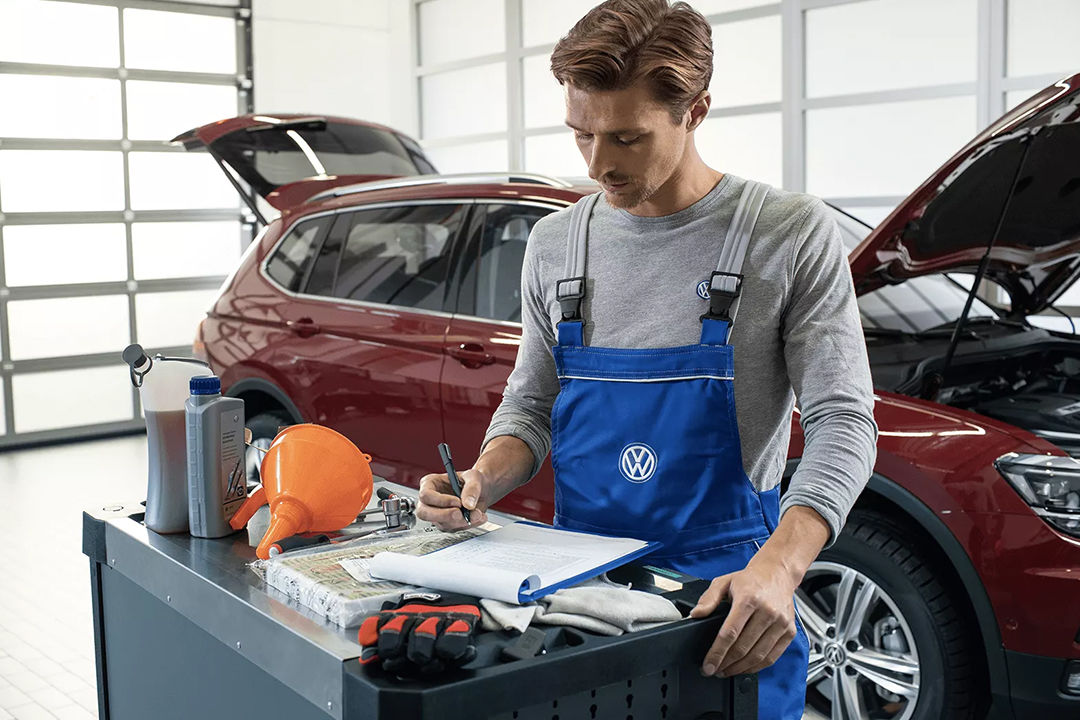 Mechanic inspecting Volkswagen car