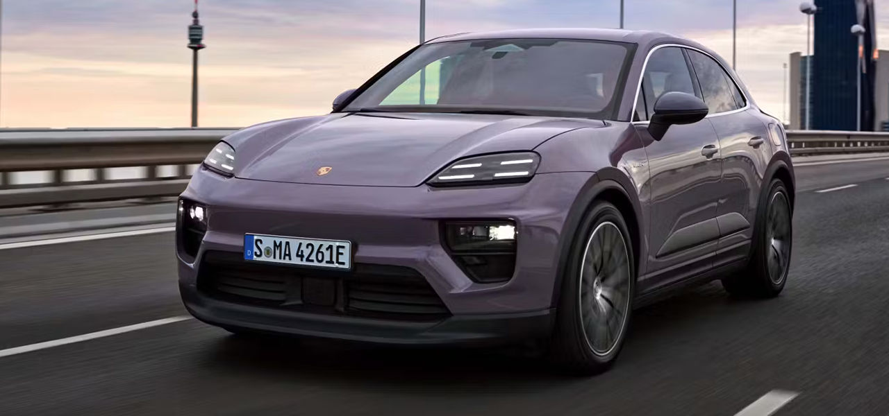 Vue 3/4 avant et latérale de la Porsche Macan EV 2024 sur route en pleine puissance