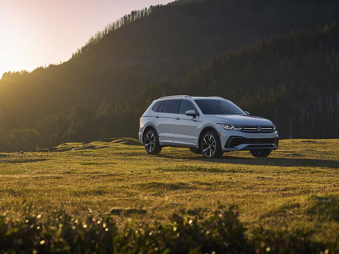 three quarter front view of the 2022 Volkswagen Tiguan parked on grass