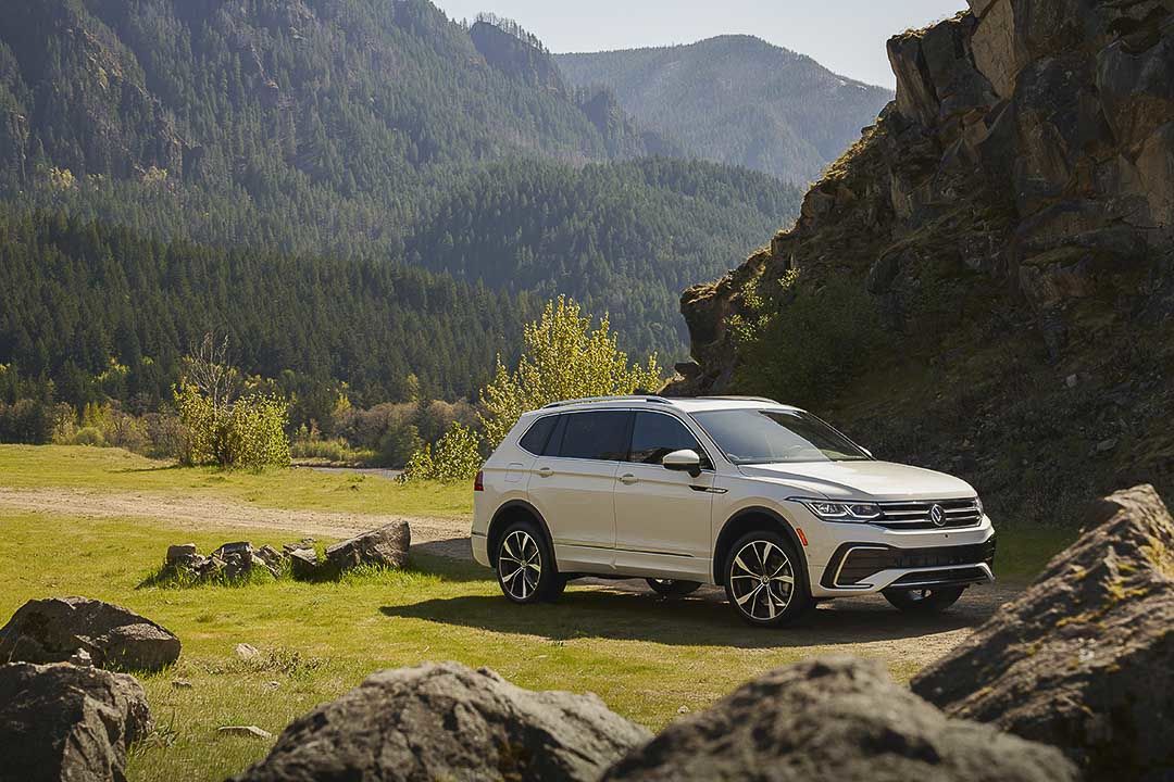 three quarter front view of the 2022 Volkswagen Tiguan parked close to large boulders