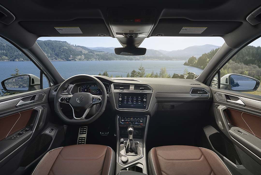 view of the main dashboard with the central control panel and the steering wheel inside of the 2022 Volkswagen Tiguan