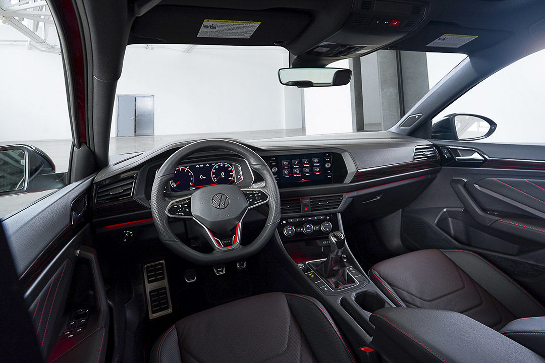 view of the central dash, steering wheel and console inside of the 2022 Volkswagen JEtta GLI
