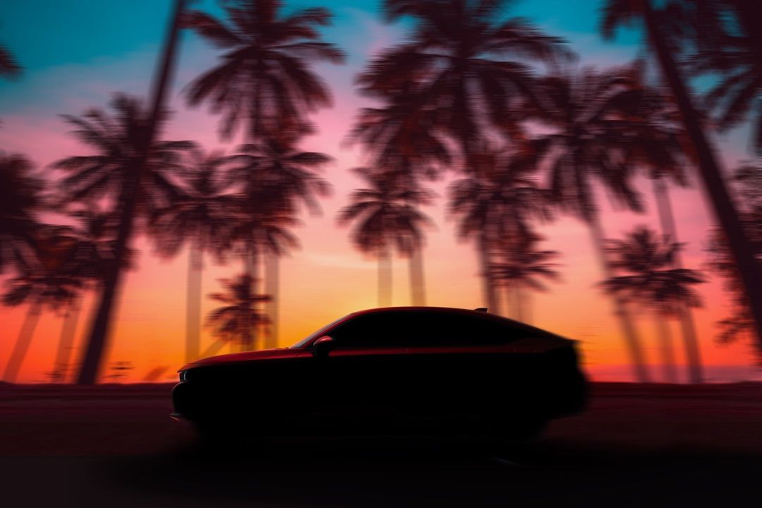 silhouette of a 2022 Honda Civic Hatchback on a tropical sunset