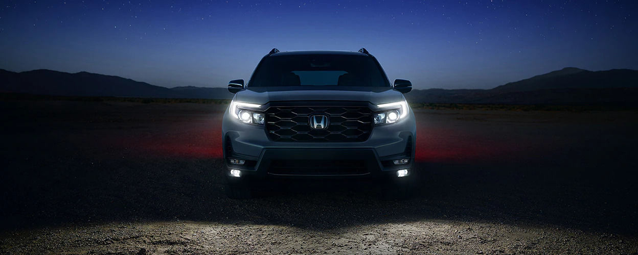 front view of a 2023 Honda Passport in the desert at night