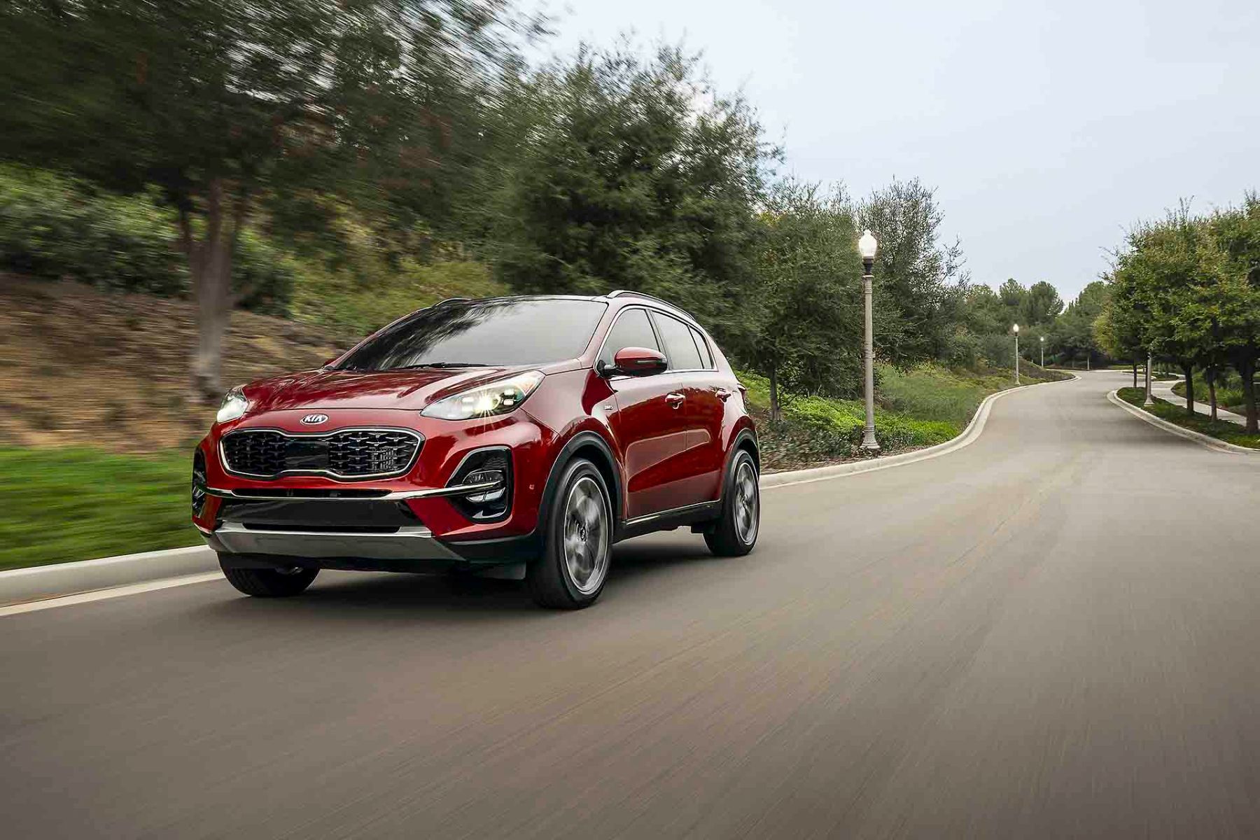 laterale front view of the 2022 Kia Sportage driving down on a road