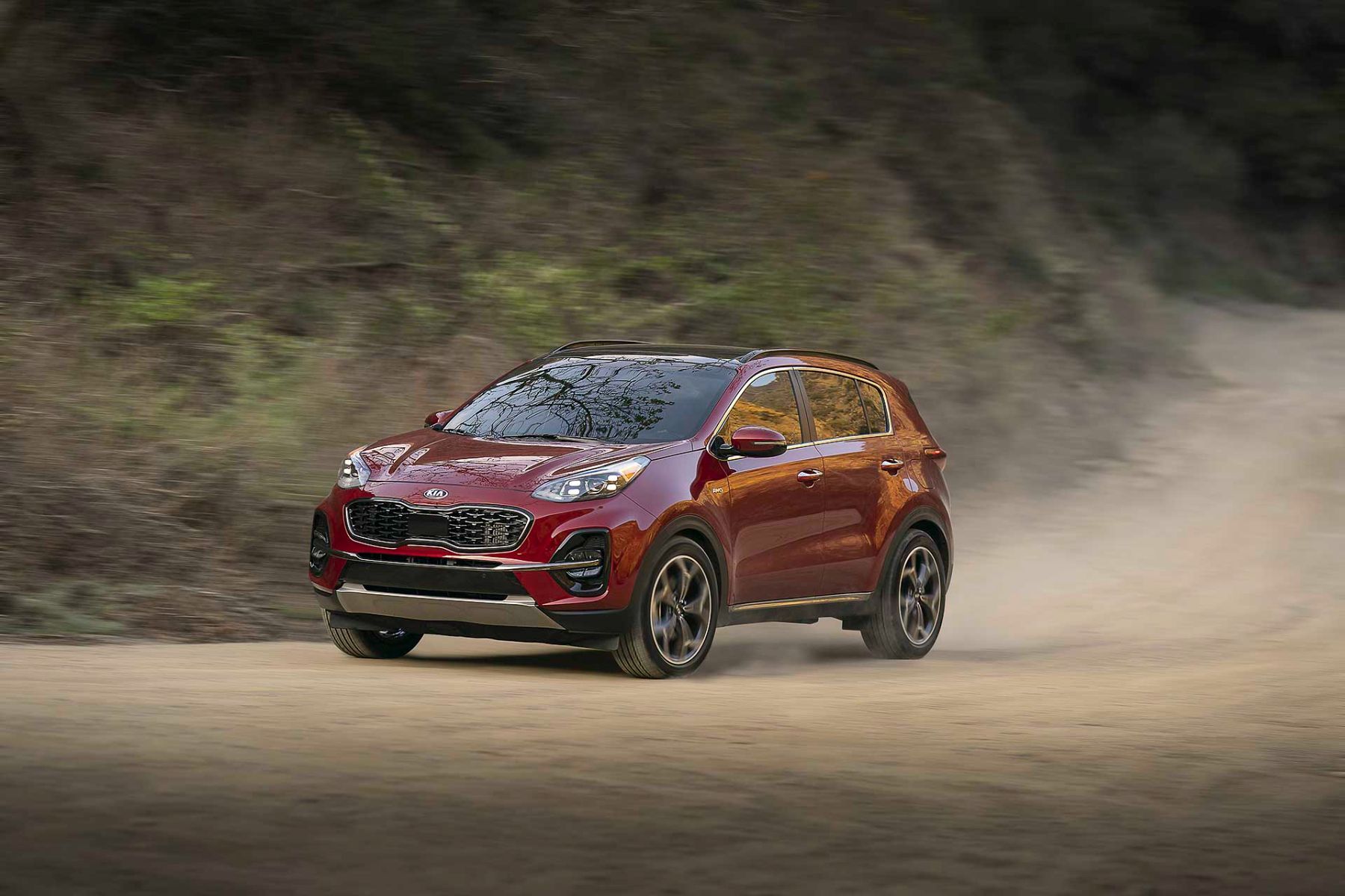 three quarter front view of the 2022 Kia Sportage on a dirt trail