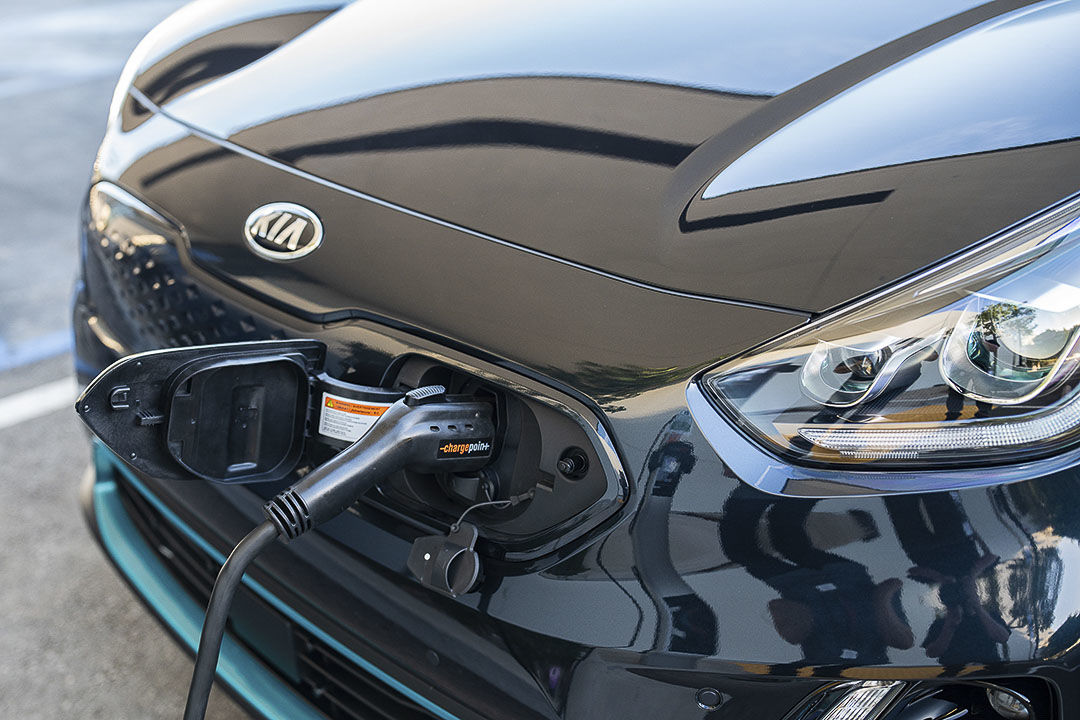 close up front view of the 2022 Kia Niro EV plugged in a charging station
