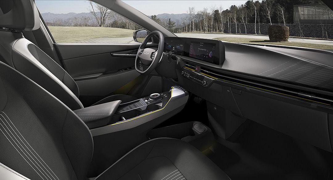 view of the dashboard, steering wheel, and front row seats inside of the 2022 Kia EV6