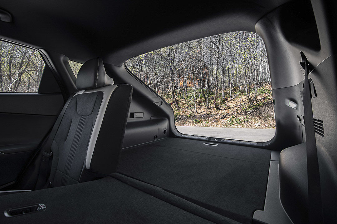 view inside of the 2022 Kia EV6 and the rear row seats with one of them folded down and the trunk open