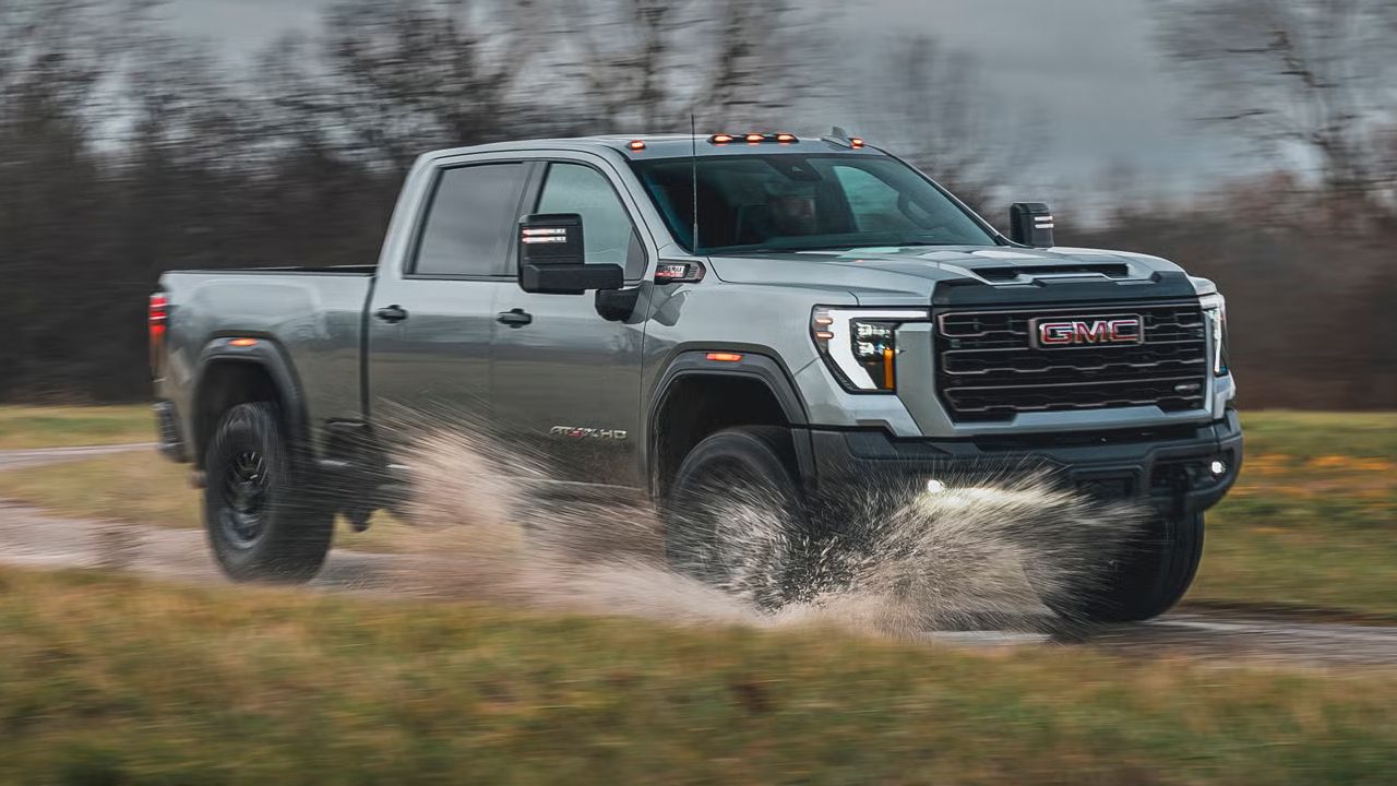 3/4 front and side view of the GMC Sierra 2500 on the road at full power in rainy conditions