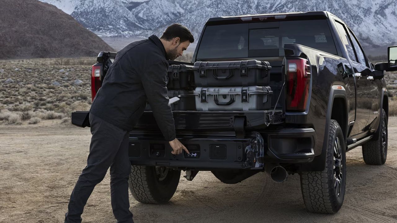 Rear view of the GMC Sierra 2500 with a man loading boxes
