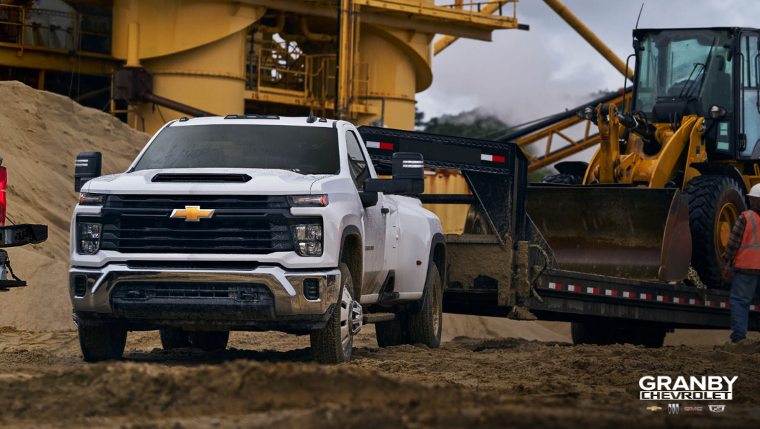 2026 Chevrolet Silverado HD towing heavy equipment.