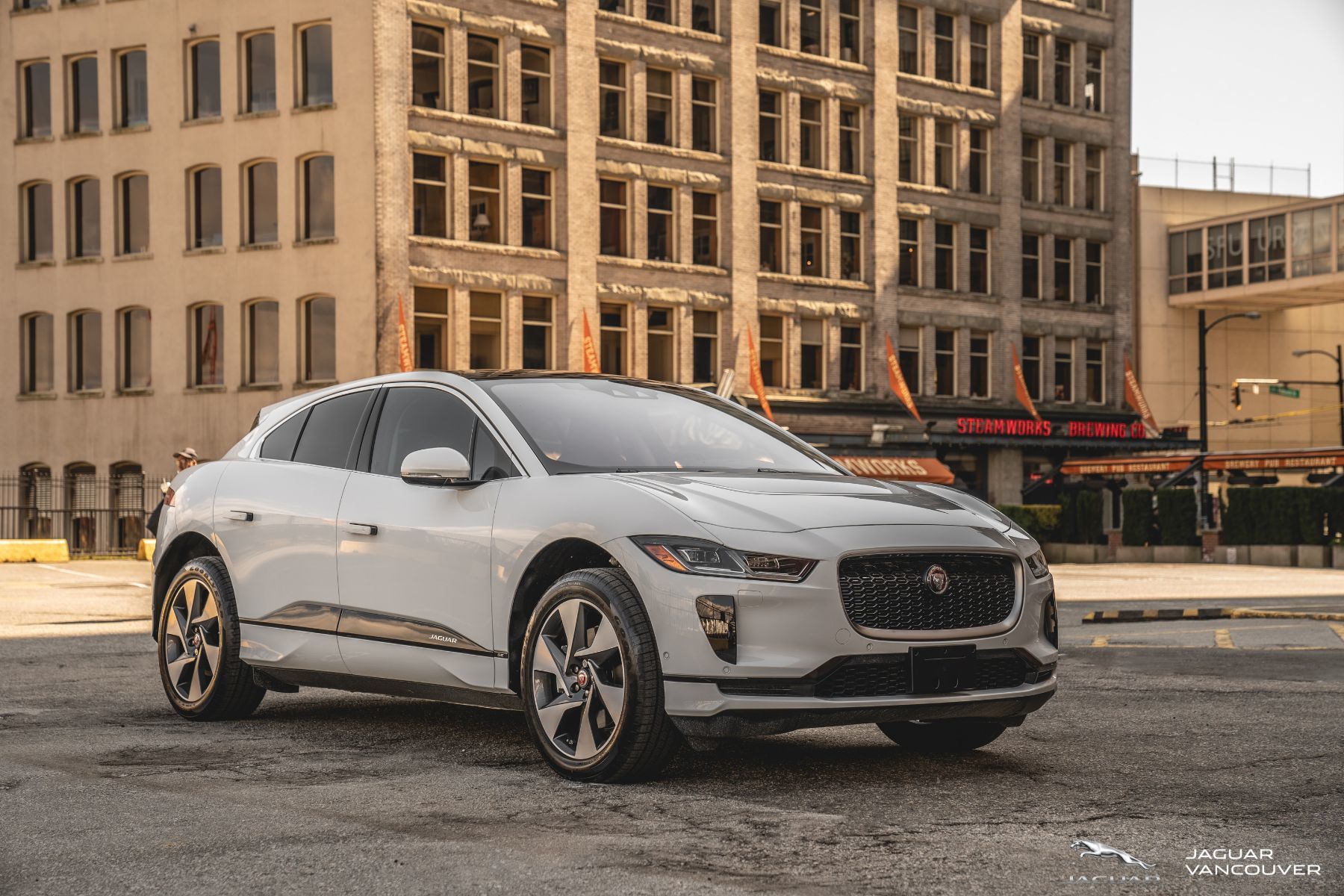 white 2020 jaguar i-pace in downtown vancouver parking lot