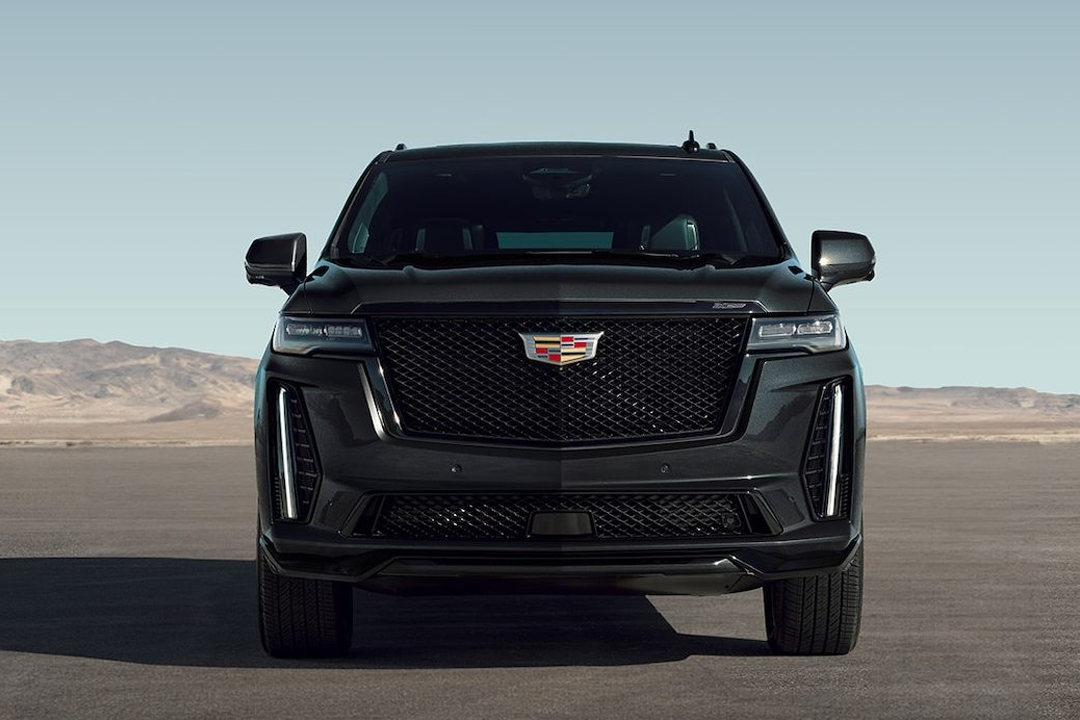 Front view of the Cadillac Escalade 2024 on a sand road