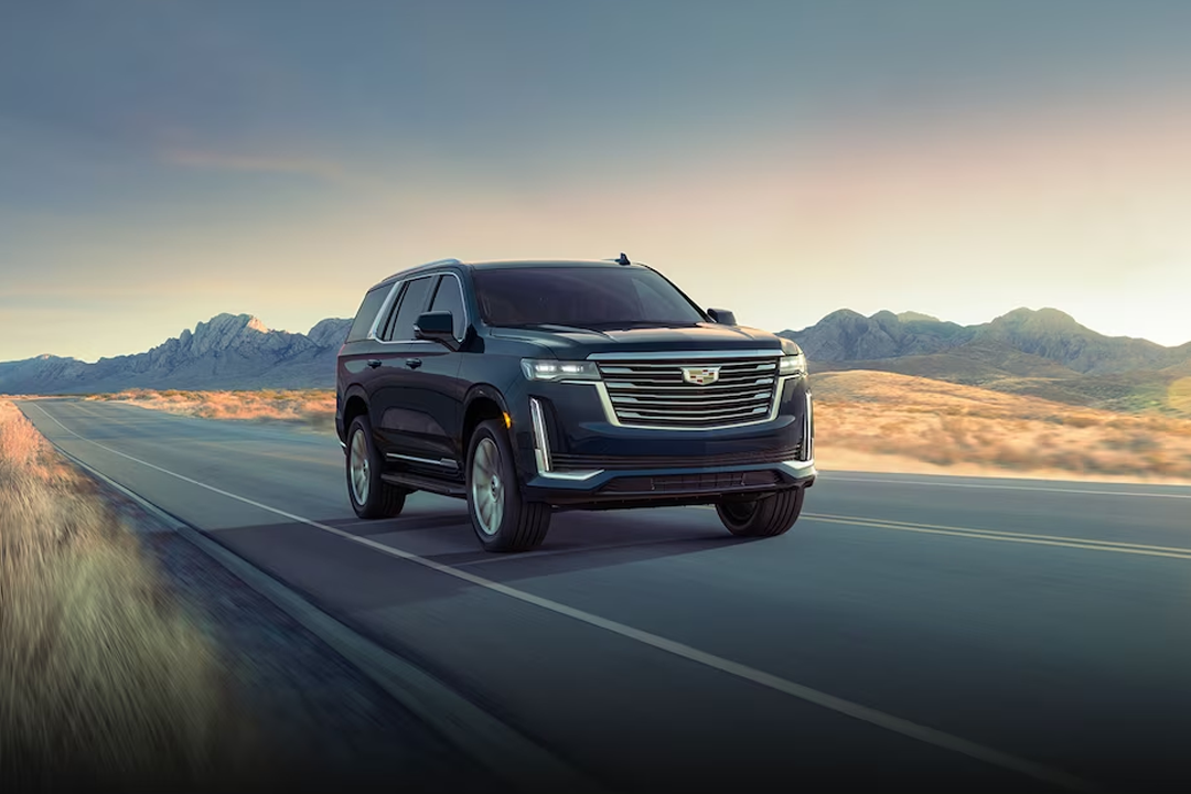 Front side view of the Cadillac Escalade 2024 on the road at full power