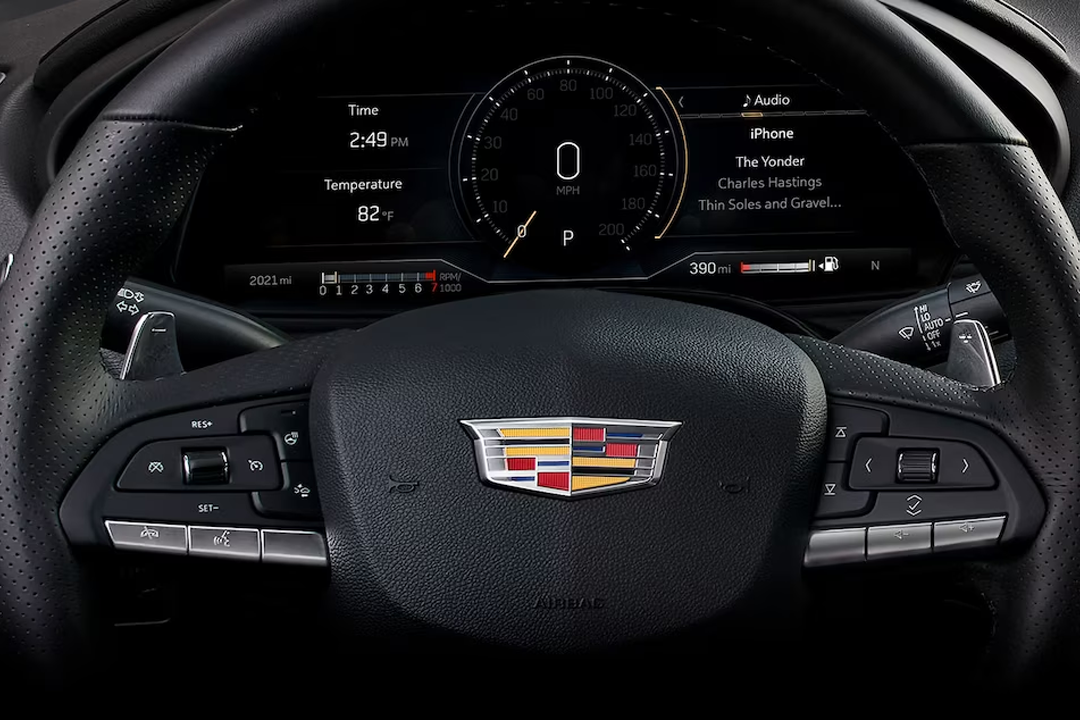 Close-up view of the Cadillac CT4 2024 steering wheel and dashboard