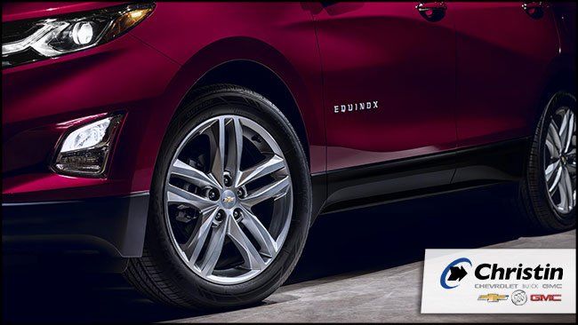 Image of the 2018 Chevrolet Equinox where you can appreciate the tires and the side of the car. Christin Automobile logo in the lower left corner.