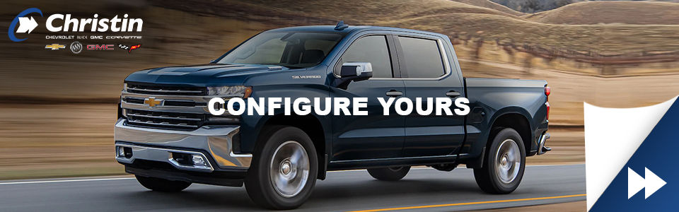 blue 2021 chevrolet silverado driving on a montreal highway with christin automobile dealership logo