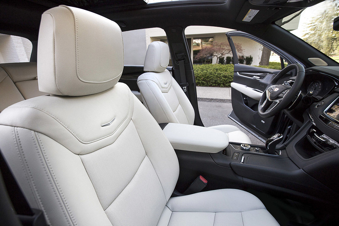 view of the front row seats, central console and steering wheel inside of the 2022 Cadillac XT5