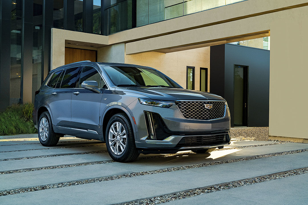 three quarter front view of the 2022 Cadillac XT6 parked in front of a house