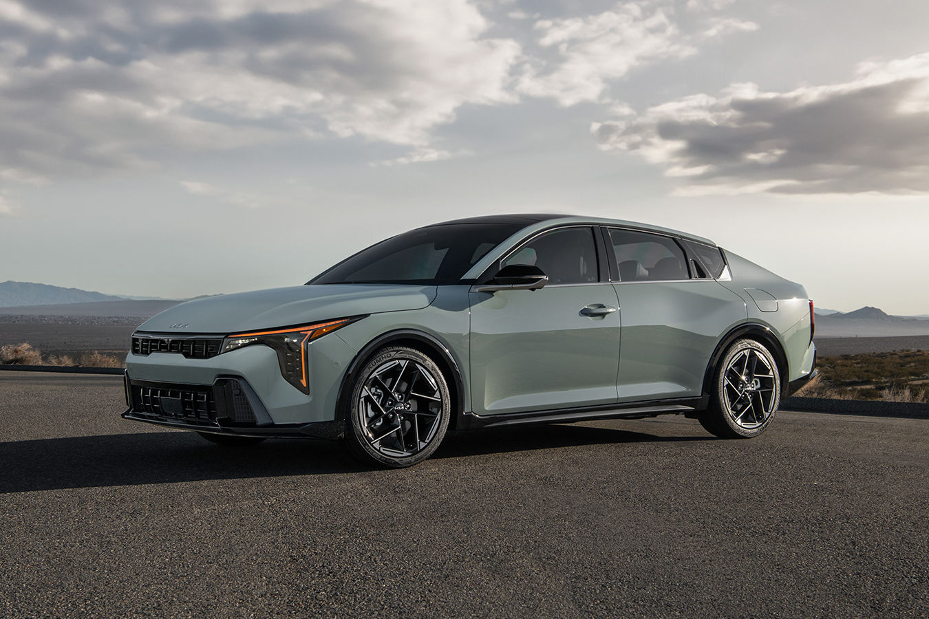 3/4 front and side view of the 2025 Kia K4 parked by the sea