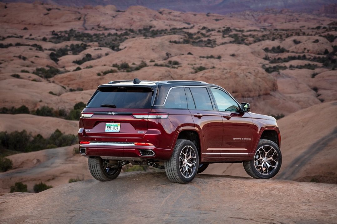 vue latérale arrière d'un Jeep Grand Cherokee 2023 sur un rocher