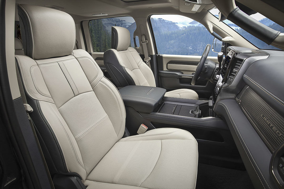 view of the front row seats, central console and steering wheel of the 2022 RAM 2500