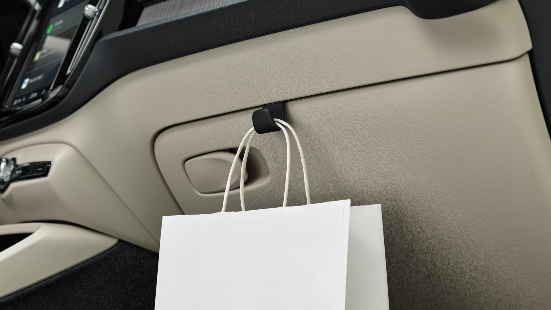 2025 Volvo XC40, interior bag hook, practical feature, smart storage, beige interior, convenience, premium design.