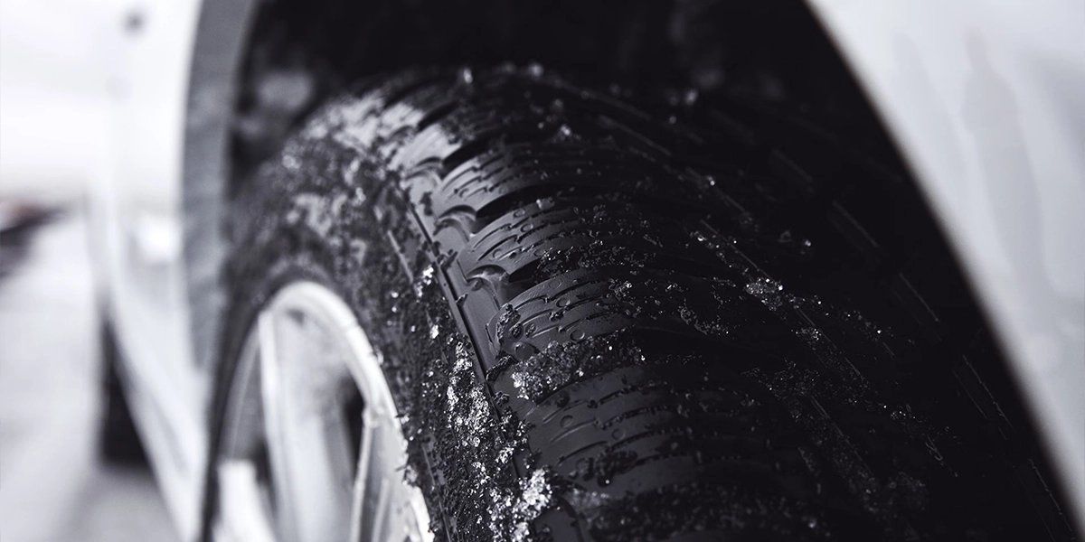 Winter tire close-up, snow grip, car safety in winter, icy roads, snow tires Volvo.