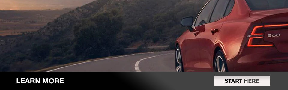 Read more: Image of a red volvo s60 driving down a road near a mountain