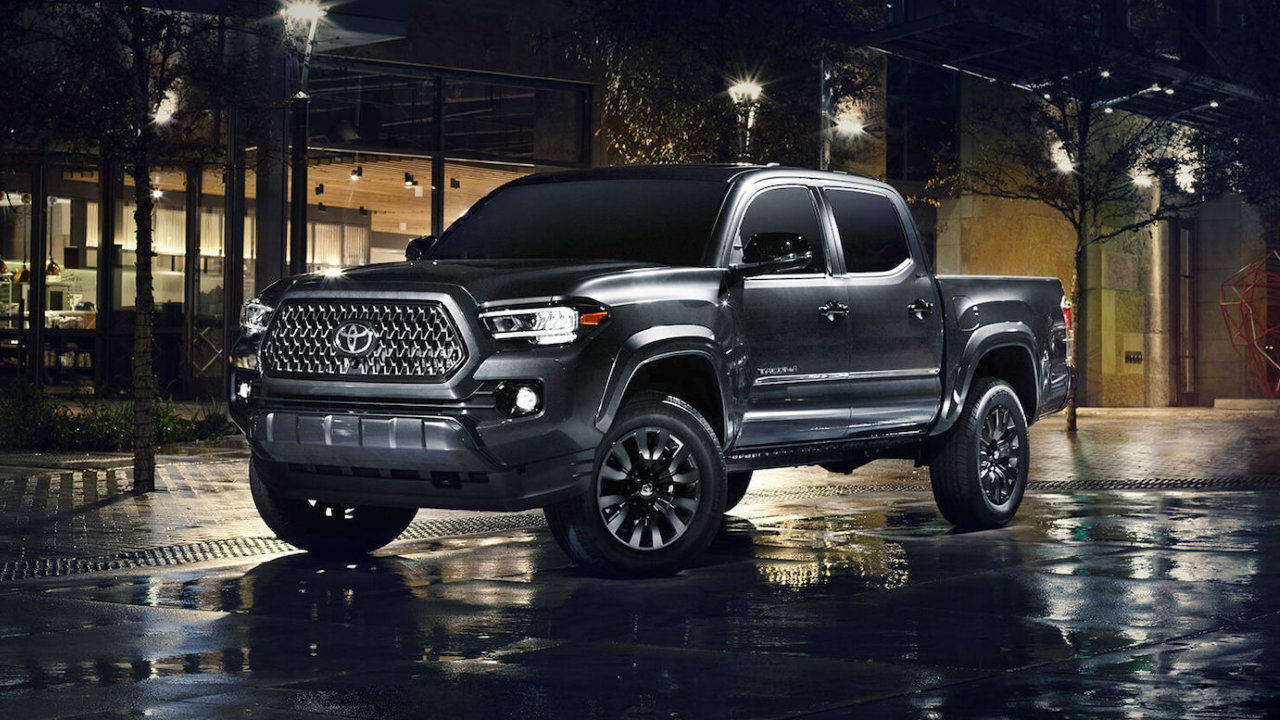 front side view of a 2022 Toyota Tacoma Nightshade in town at night