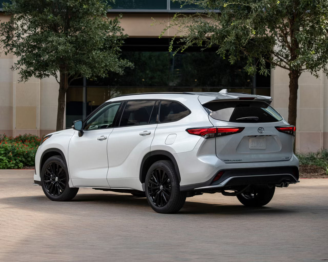 back view of a 2025 Toyota Highlander parked in front of a house