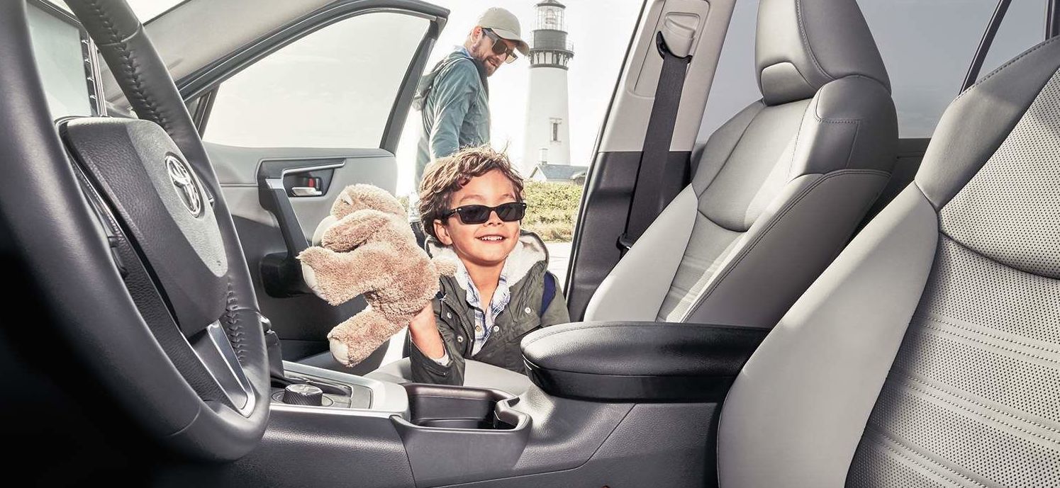 child with his cuddly toy entering the 2021 Toyota RAV4 Limited AWD