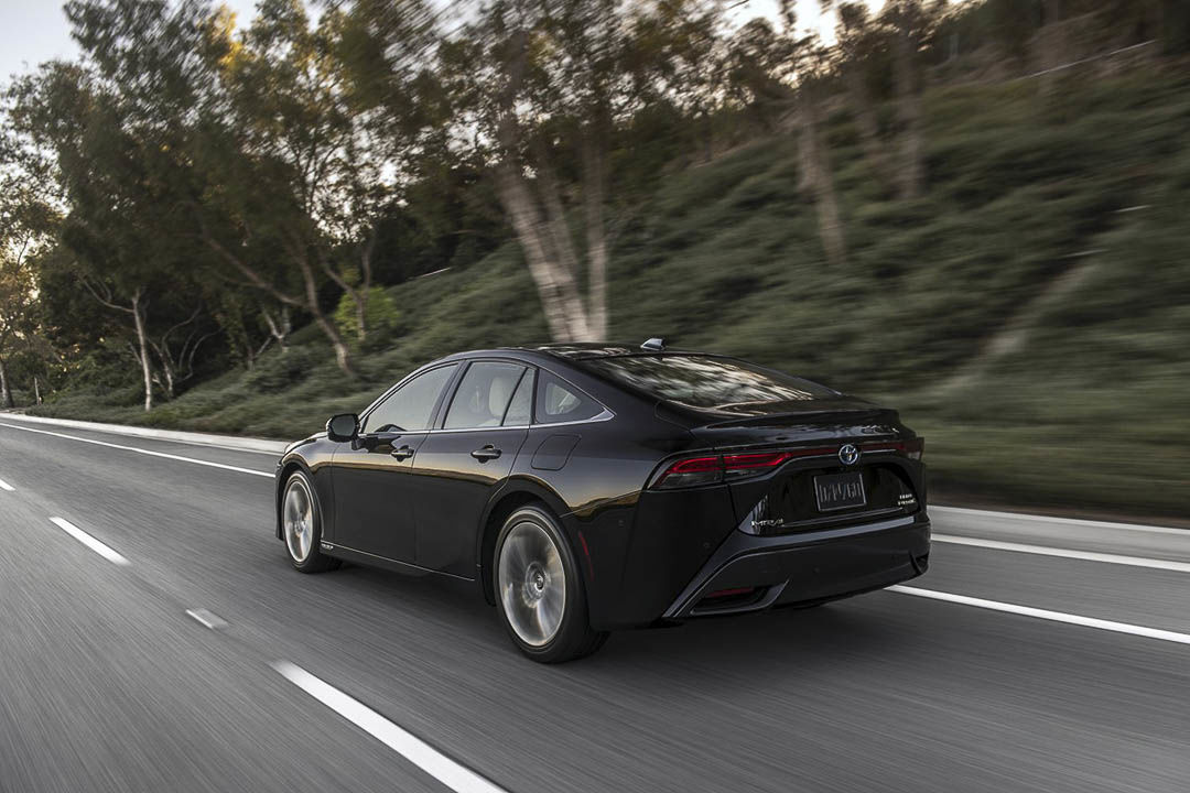 rear view of the 2021 Toyota Mirai driven on a road