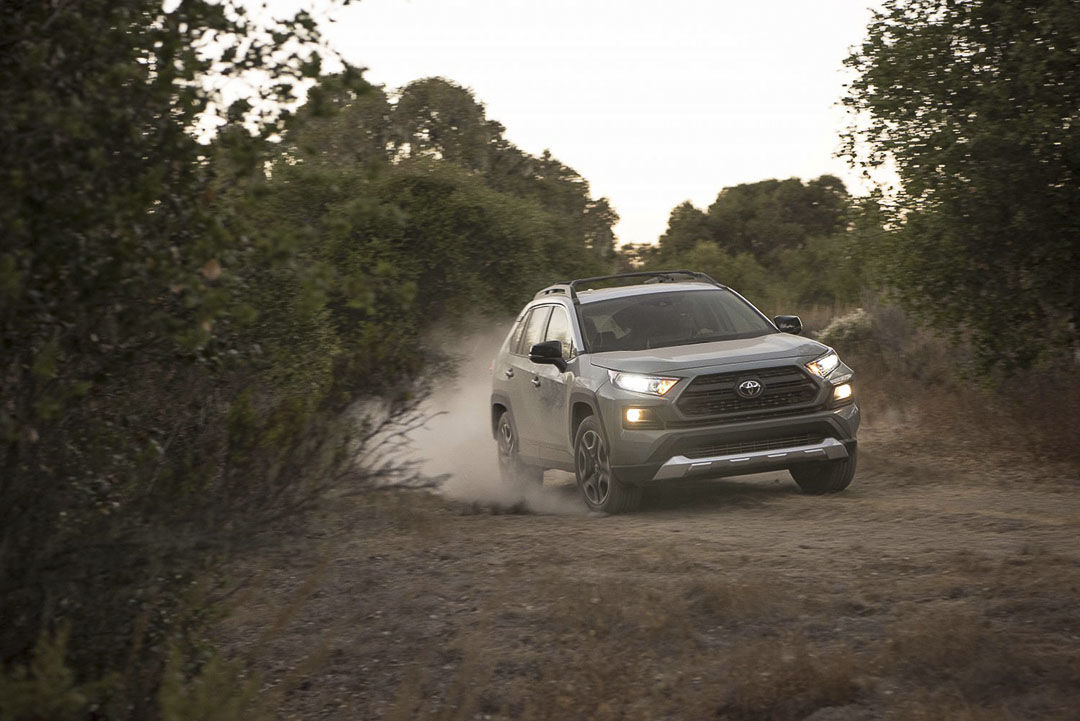 front view of the 2021 Toyota RAV4 driven on a dusty trail