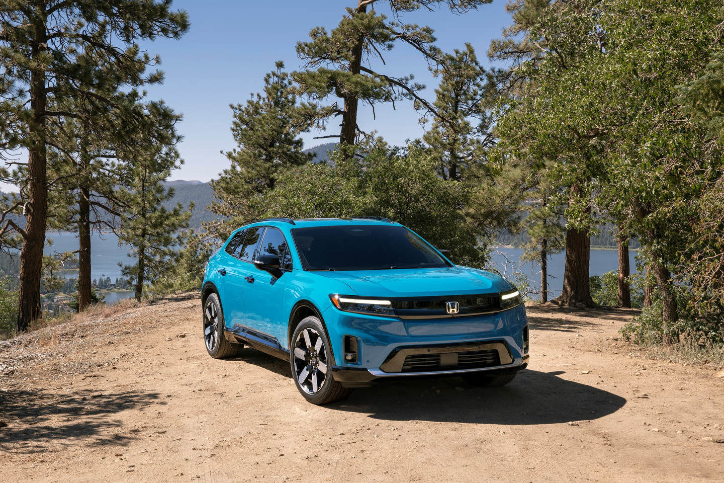 Blue 2024 Honda Prologue parked on dirt road overlooking lake - The Humberview Group