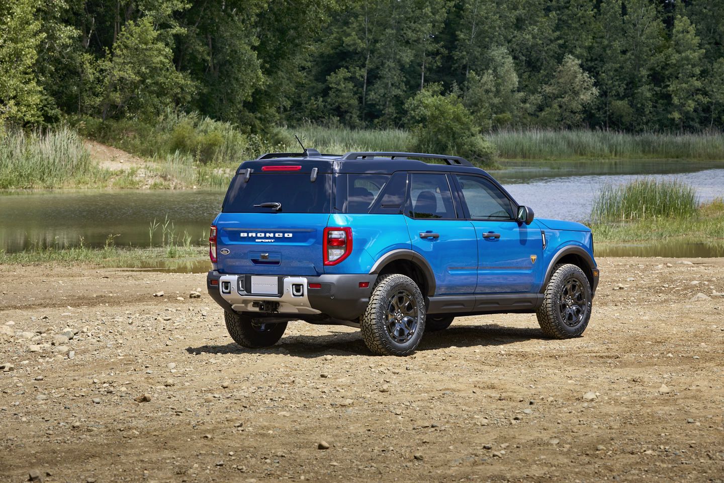 2025 Ford Bronco Sport - rear view of a blue 2025 Ford Bronco Sport parked on a dirt patch near a lake - Mayfield Ford - Ford car dealership in Brampton, Ontario