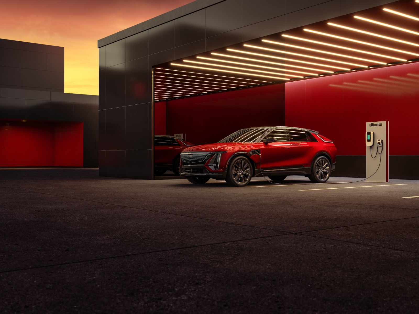 2025 Cadillac Lyriq - a red 2025 Cadillac Lyriq at a charging station inside a garage - City Cadillac - Cadillac car dealership in Toronto, Ontario
